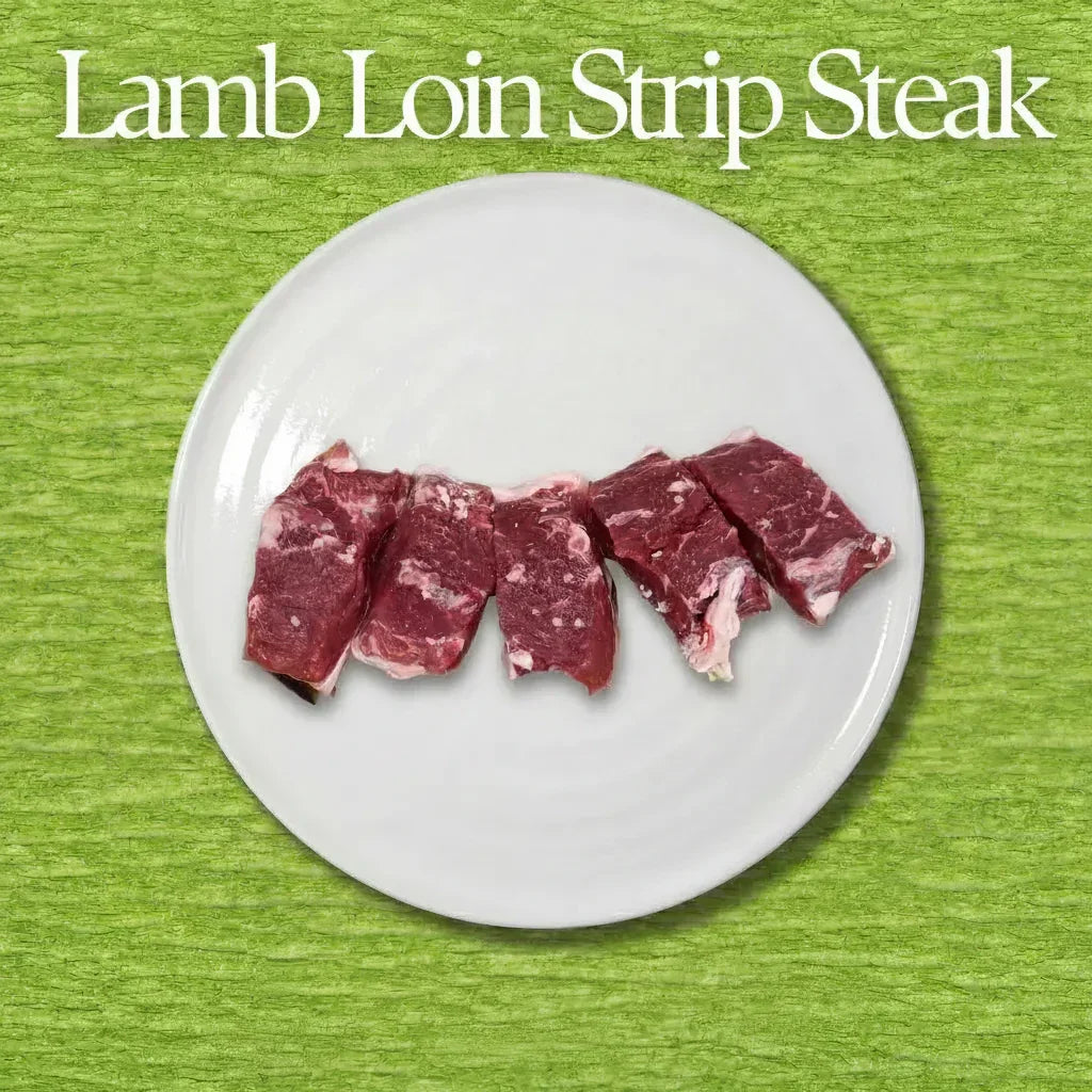 Raw lamb loin strip steak on a white plate with a green background