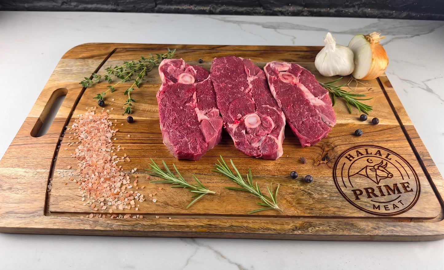 Raw lamb leg slices on a wooden cutting board with herbs and spices, featuring Halal Prime Meat branding.