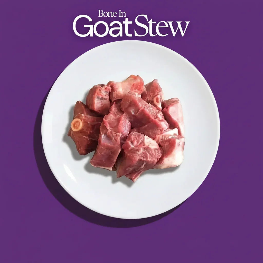 Raw goat stew meat on a white plate with 'Bone In Goat Stew' text on a purple background