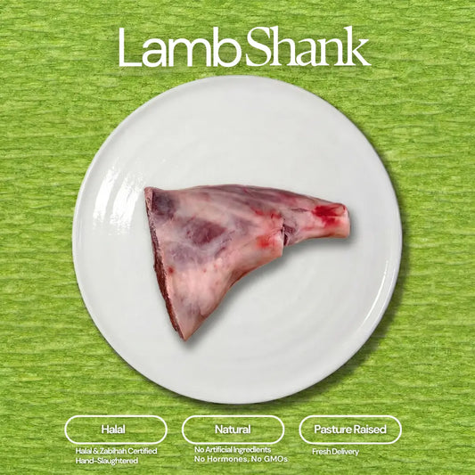 Photograph of a raw lamb shank centered on a white plate against a vibrant green textured background, topped by the text "Lamb Shank" and accompanied by informational badges highlighting its Halal, Natural, and Pasture Raised attributes