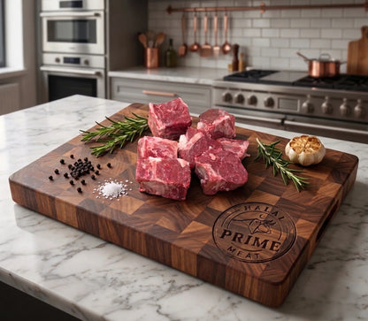 Raw Lamb Chuck on a wooden cutting board with herbs and spices in a kitchen setting.